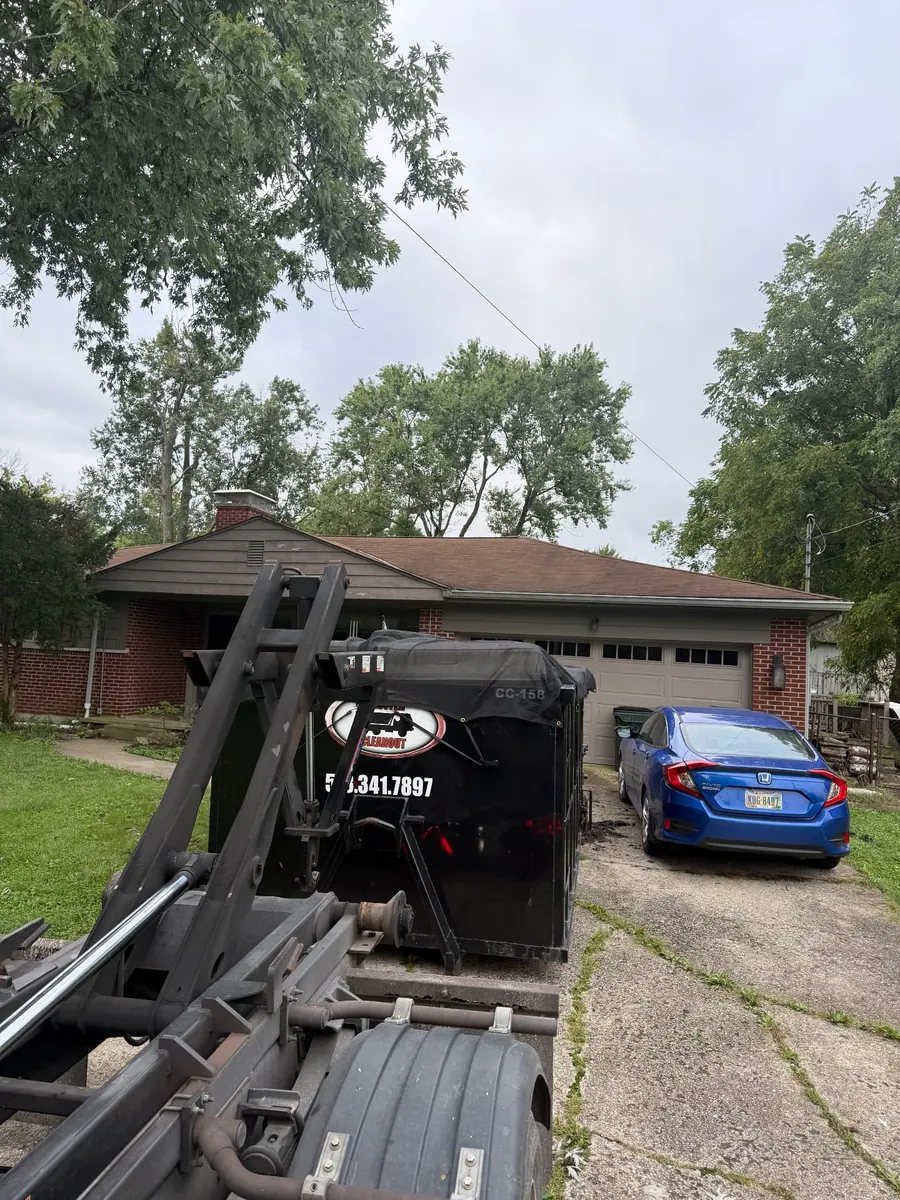 Clutter Cleanout 15 yard dumpster CC-158 delivered by roll-off truck to a residential driveway in Maineville, OH