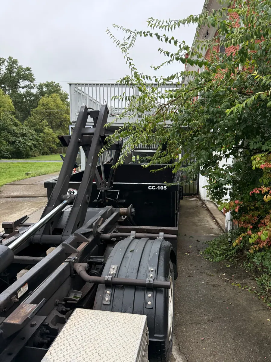 Clutter Cleanout 10 yard dumpster CC-105 delivered by roll-off truck to a residential driveway in Milford, OH