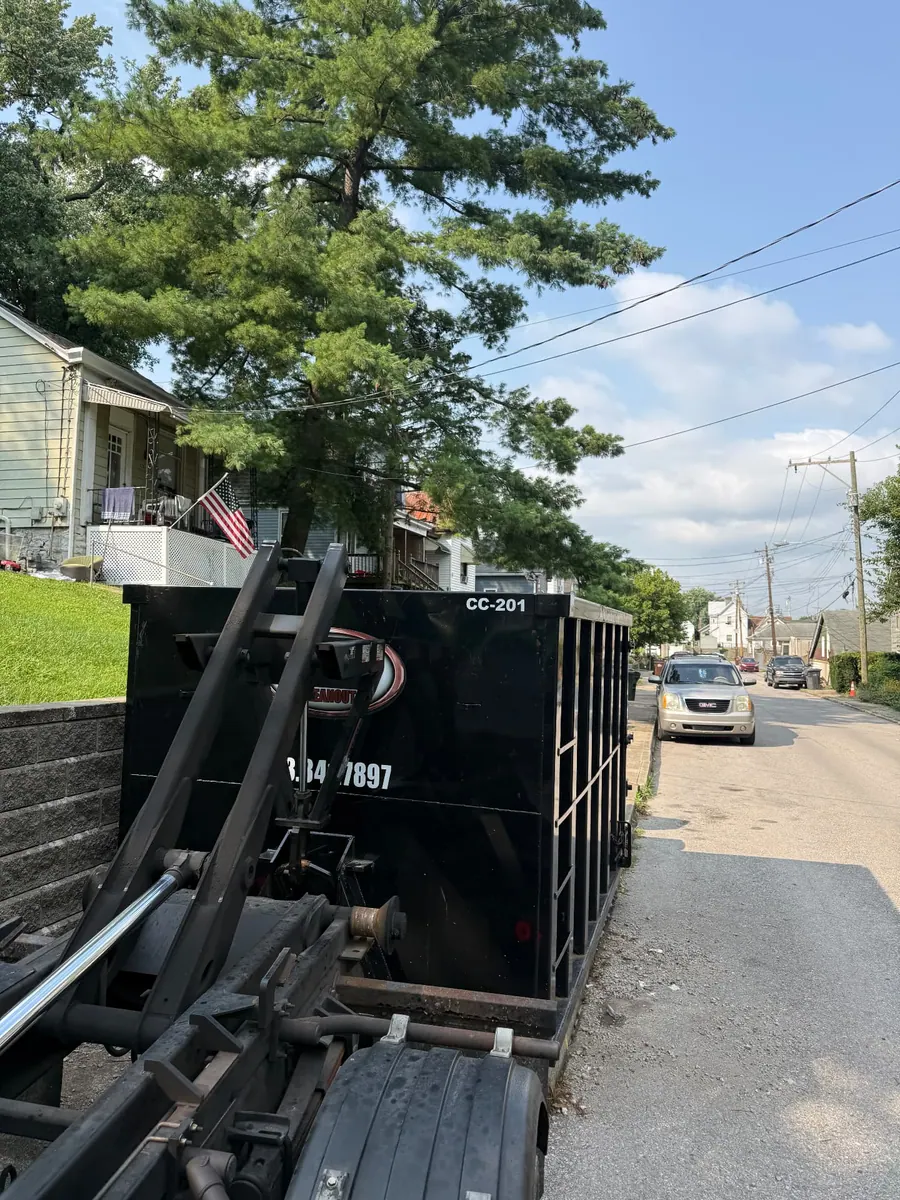 Clutter Cleanout 20 yard dumpster CC-201 being set street-side on a Covington KY neighborhood street