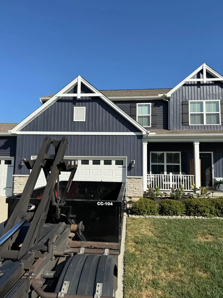 Clutter Cleanout 10 yard dumpster CC-104 delivered by roll-off truck to a residential driveway in Maineville, OH