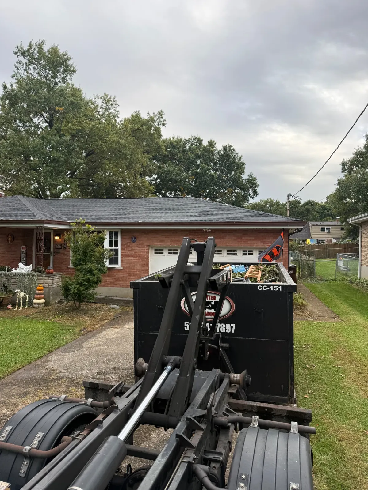 Clutter Cleanout 15 yard dumpster CC-151 loaded with household debris on a residential driveway in Cincinnati, OH
