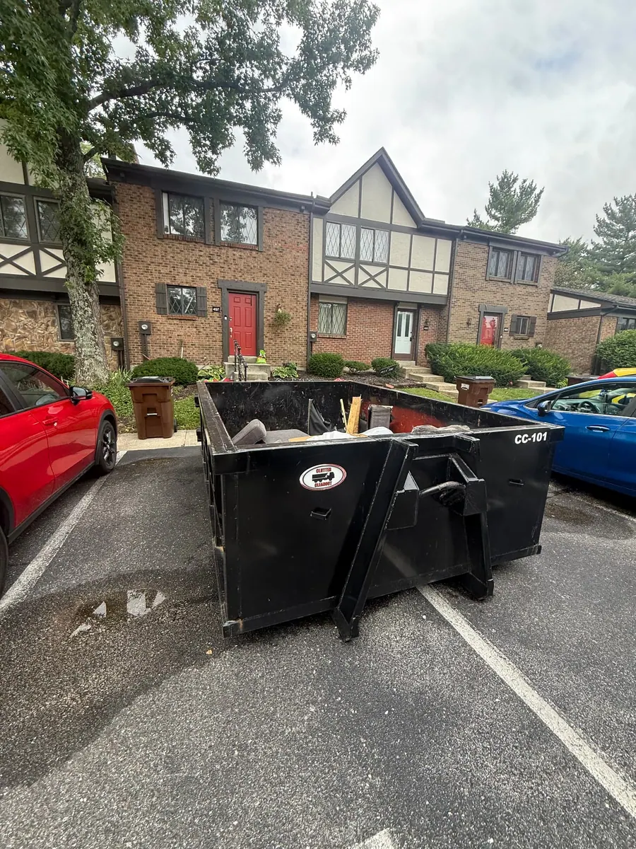 Clutter Cleanout 10 yard dumpster CC-101 loaded with furniture in a Batavia OH townhome parking lot