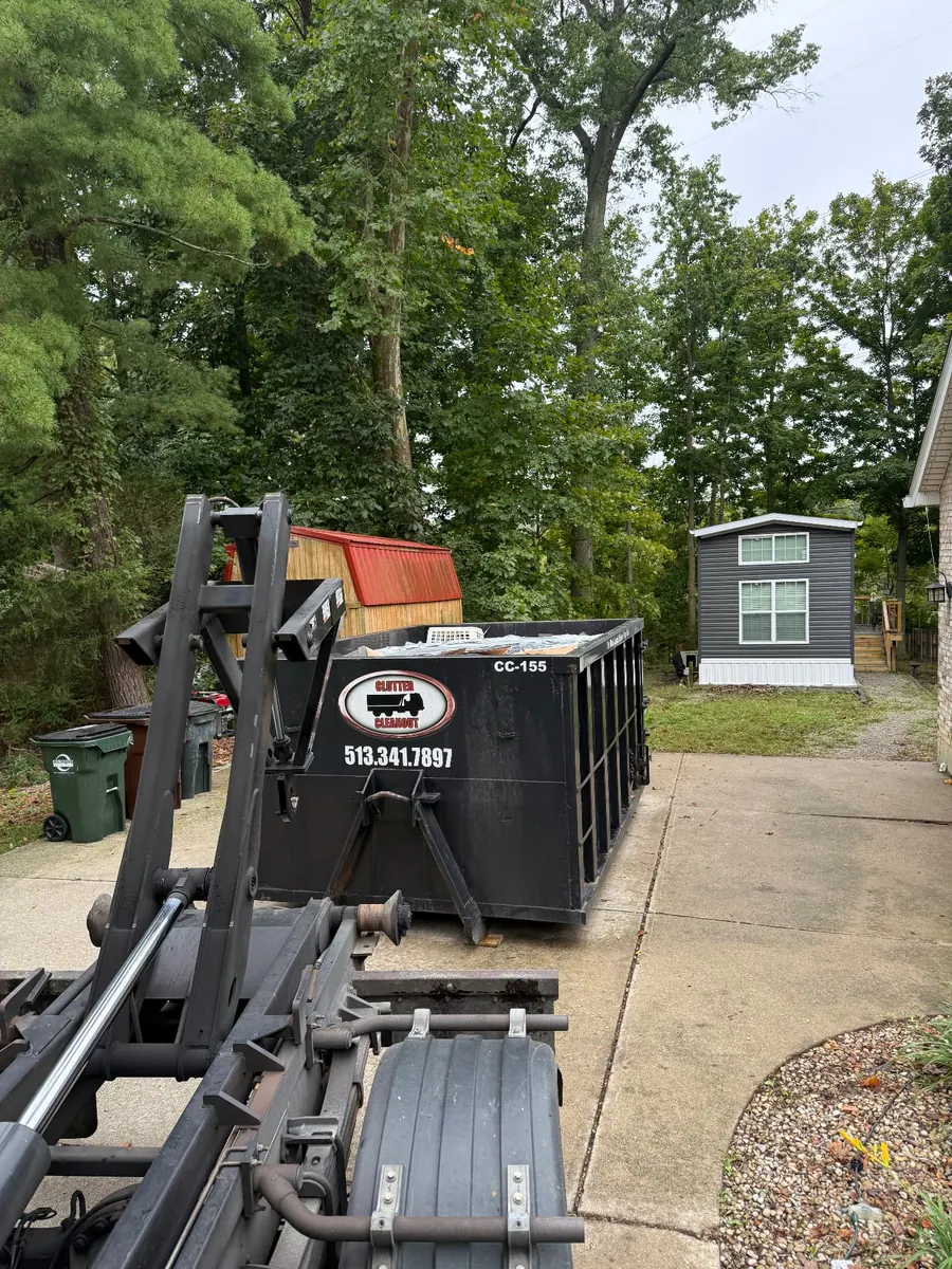 Clutter Cleanout 15 yard dumpster CC-155 delivered by roll-off truck to a residential driveway in Loveland, OH