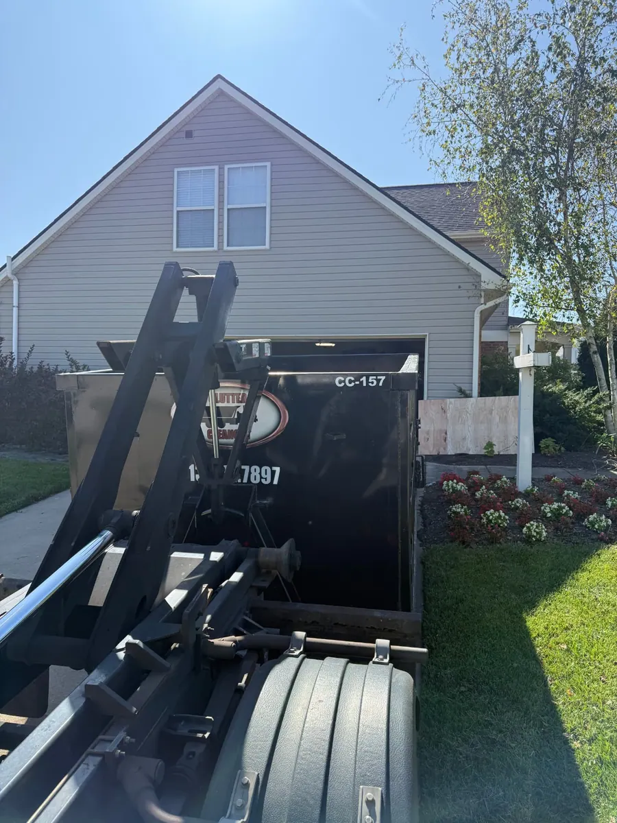 Clutter Cleanout 15 yard dumpster CC-157 delivered by roll-off truck to a residential driveway in Batavia, OH