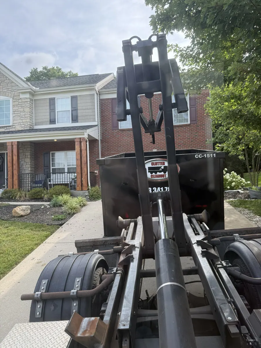 Clutter Cleanout 15 yard dumpster CC-1511 delivered to a brick and stone home driveway in Independence, KY