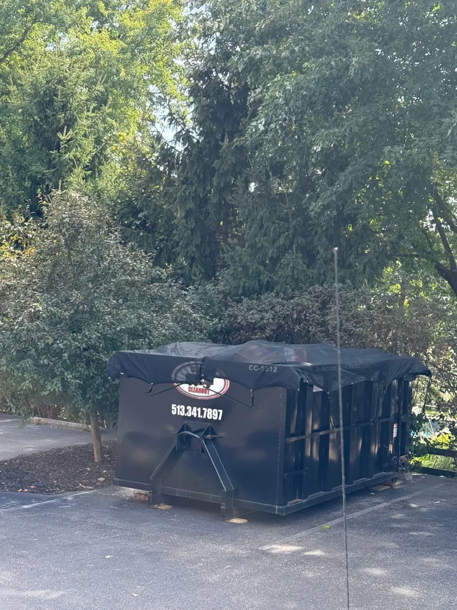 Tarped Clutter Cleanout 15 yard dumpster CC-1512 placed on a residential driveway in Loveland, OH