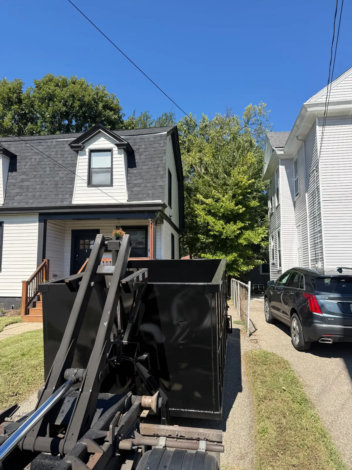 Clutter Cleanout 15 yard dumpster delivered to a narrow residential driveway in Norwood, OH