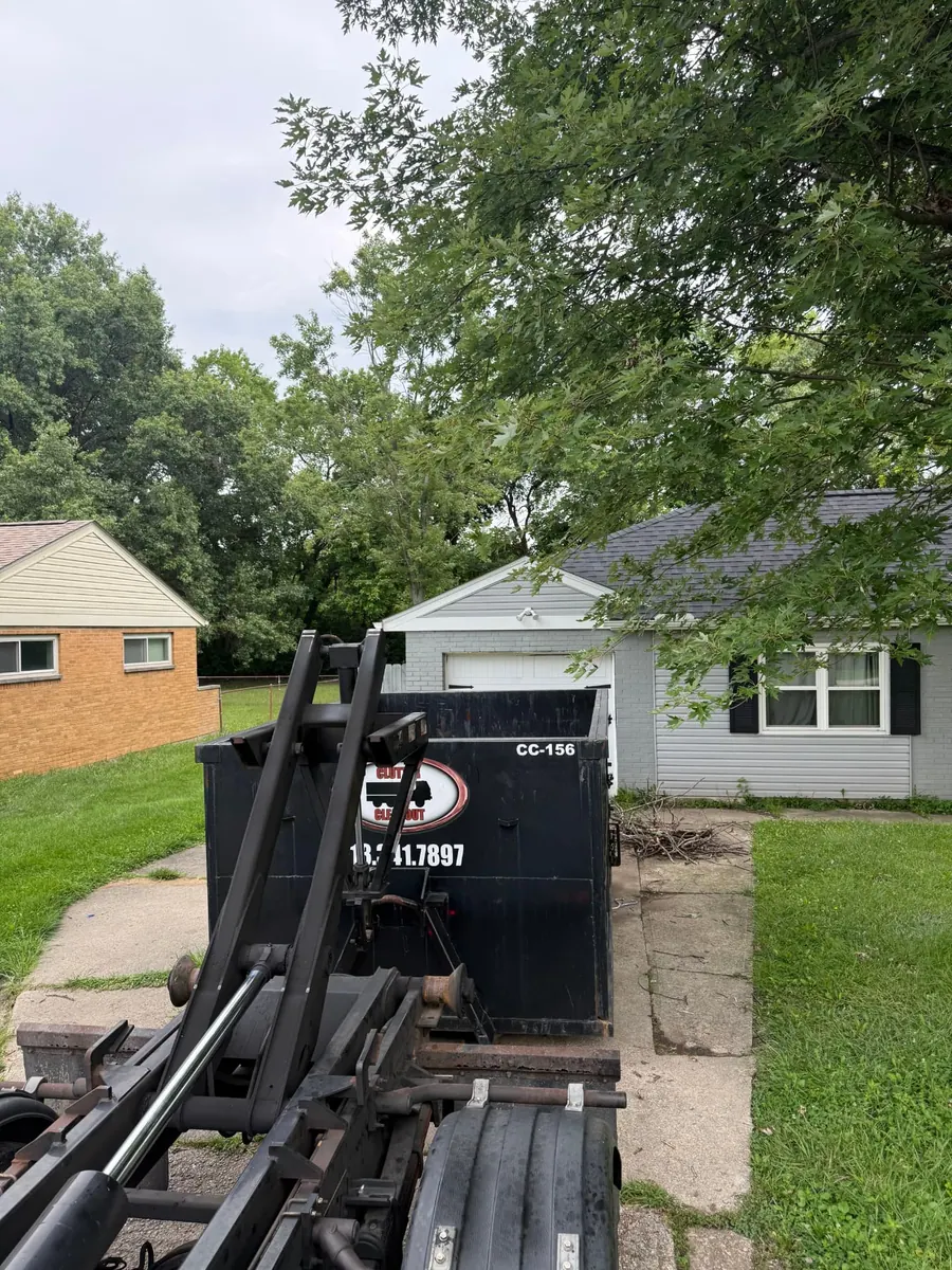 Clutter Cleanout 15 yard dumpster CC-156 set on a driveway in front of a garage in West Chester, OH