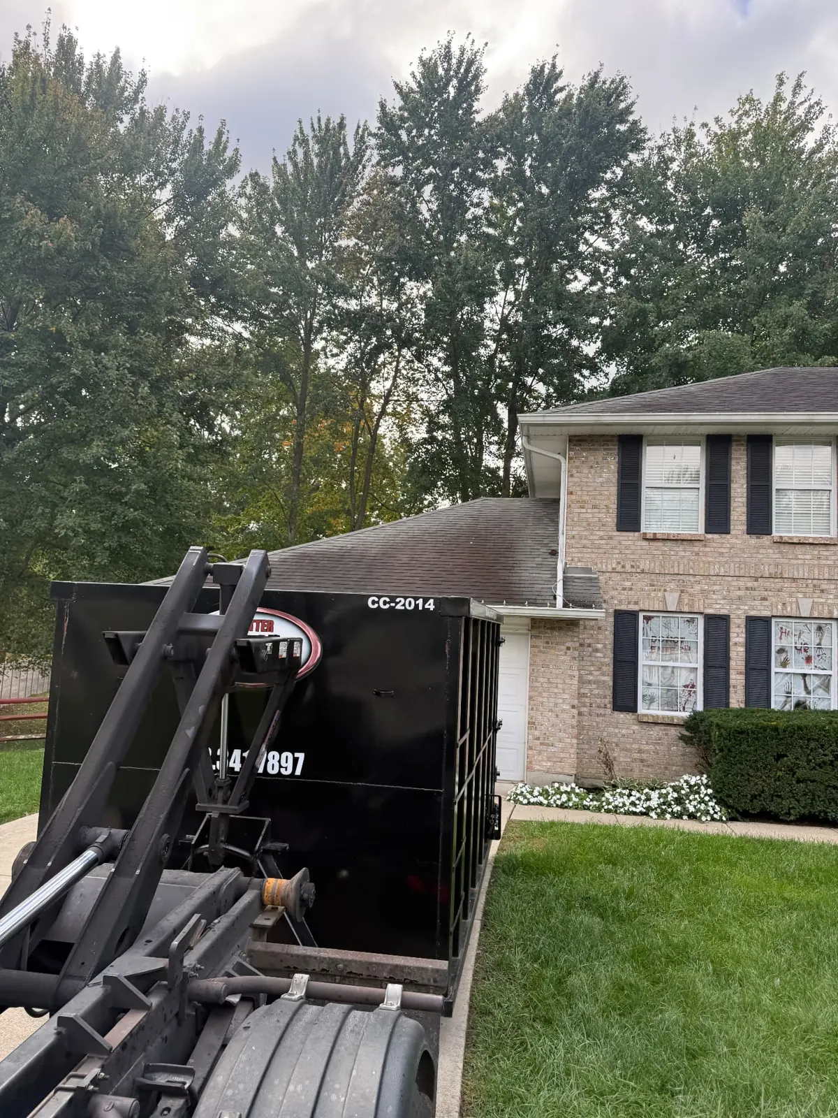 Clutter Cleanout 20 yard dumpster CC-2014 delivered beside a two-story brick home in Batavia, OH