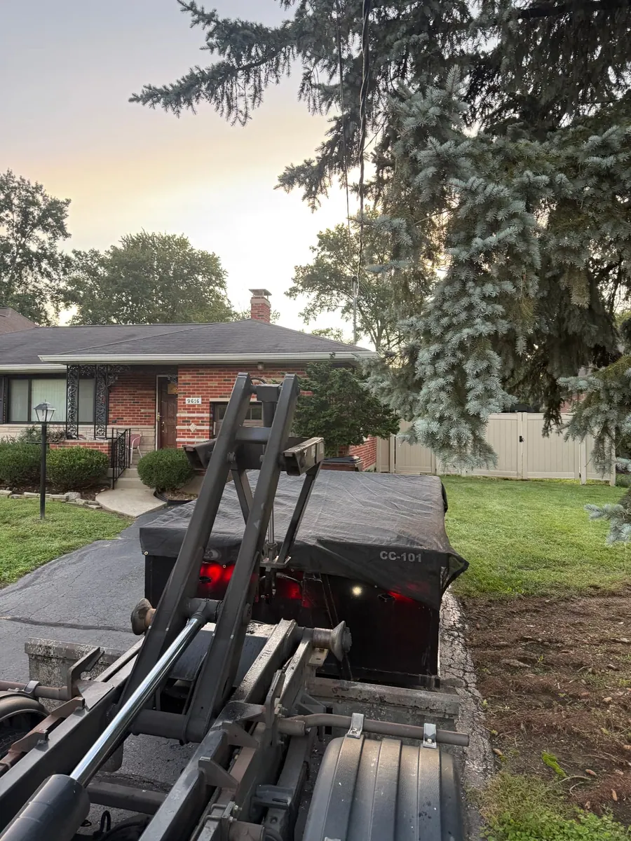 Clutter Cleanout 10 yard dumpster CC-101 delivered by roll-off truck to a residential driveway in Montgomery, OH