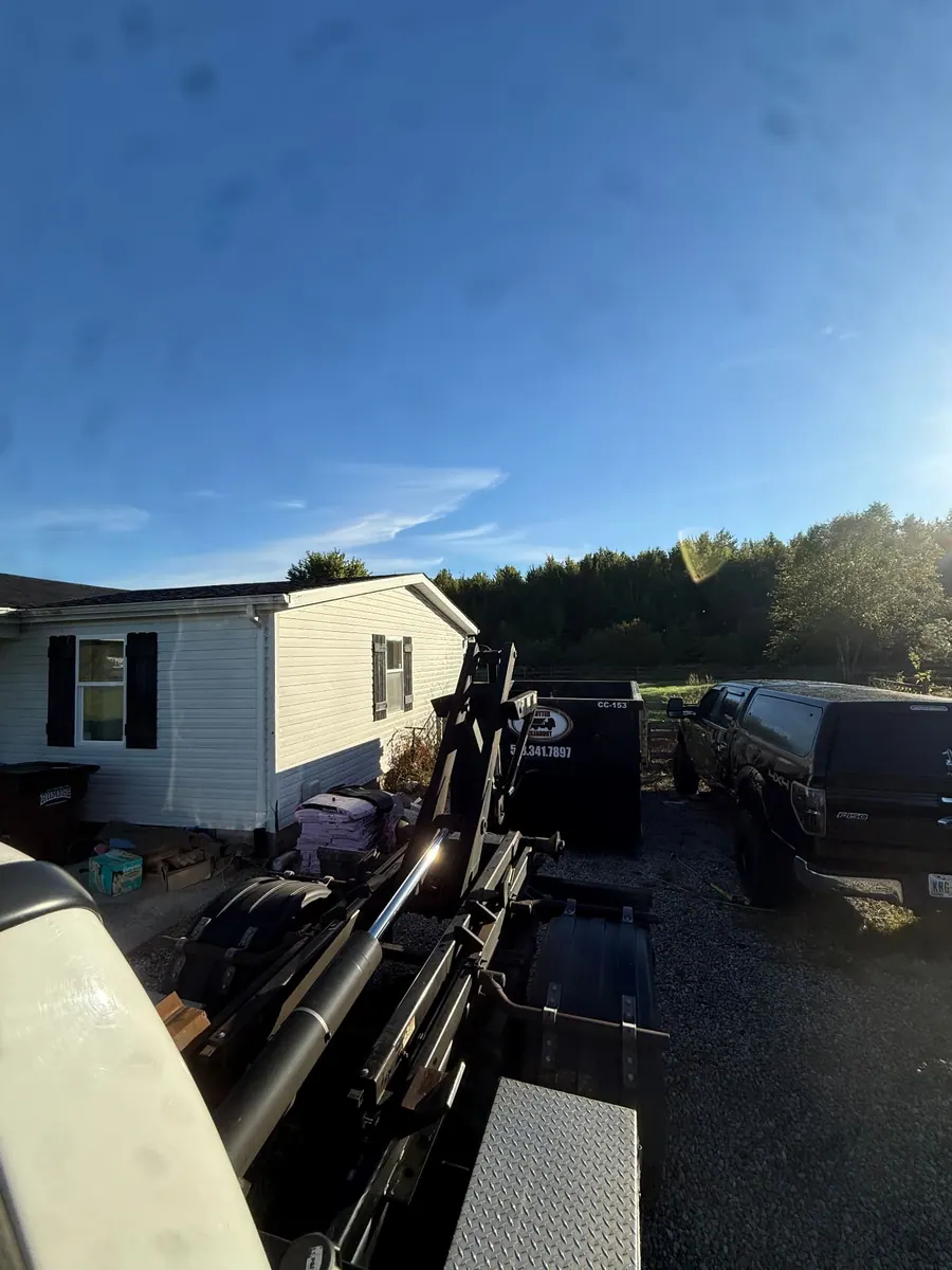 Clutter Cleanout 15 yard dumpster CC-153 delivered by roll-off truck to a residential driveway in Milford, OH