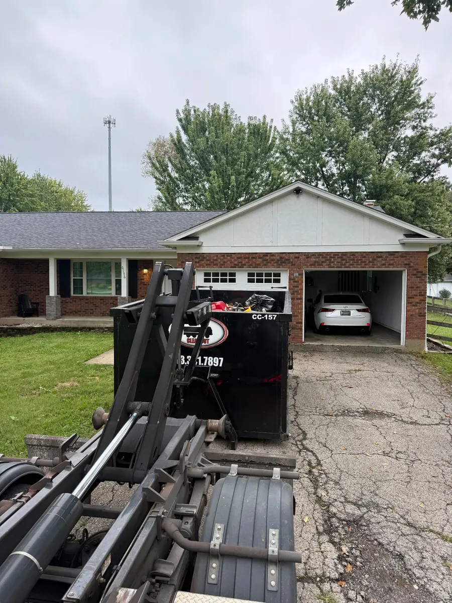 Loaded Clutter Cleanout 15 yard dumpster CC-157 collected by roll-off truck from a residential driveway in Milford, OH