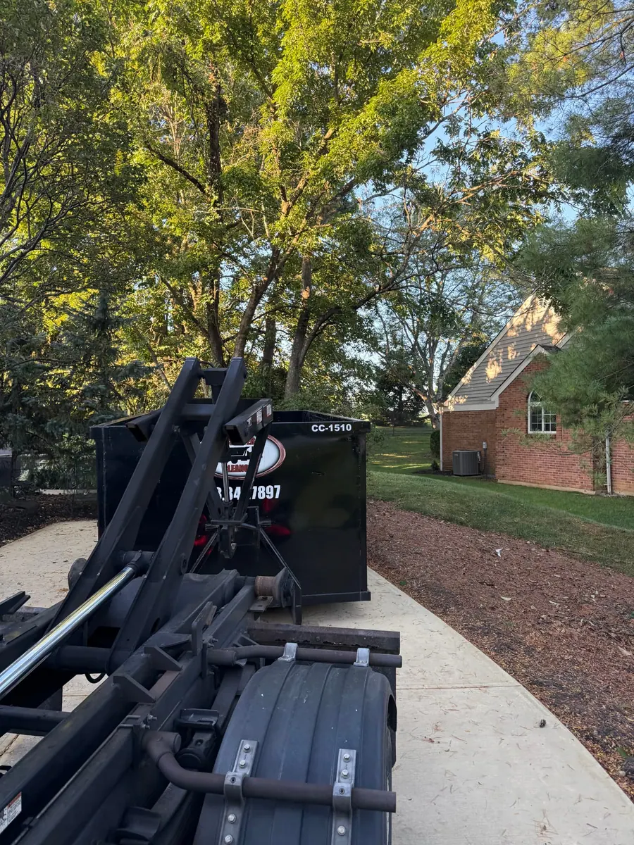 Clutter Cleanout 15 yard dumpster CC-1510 delivered by roll-off truck to a residential driveway in Anderson Township, OH