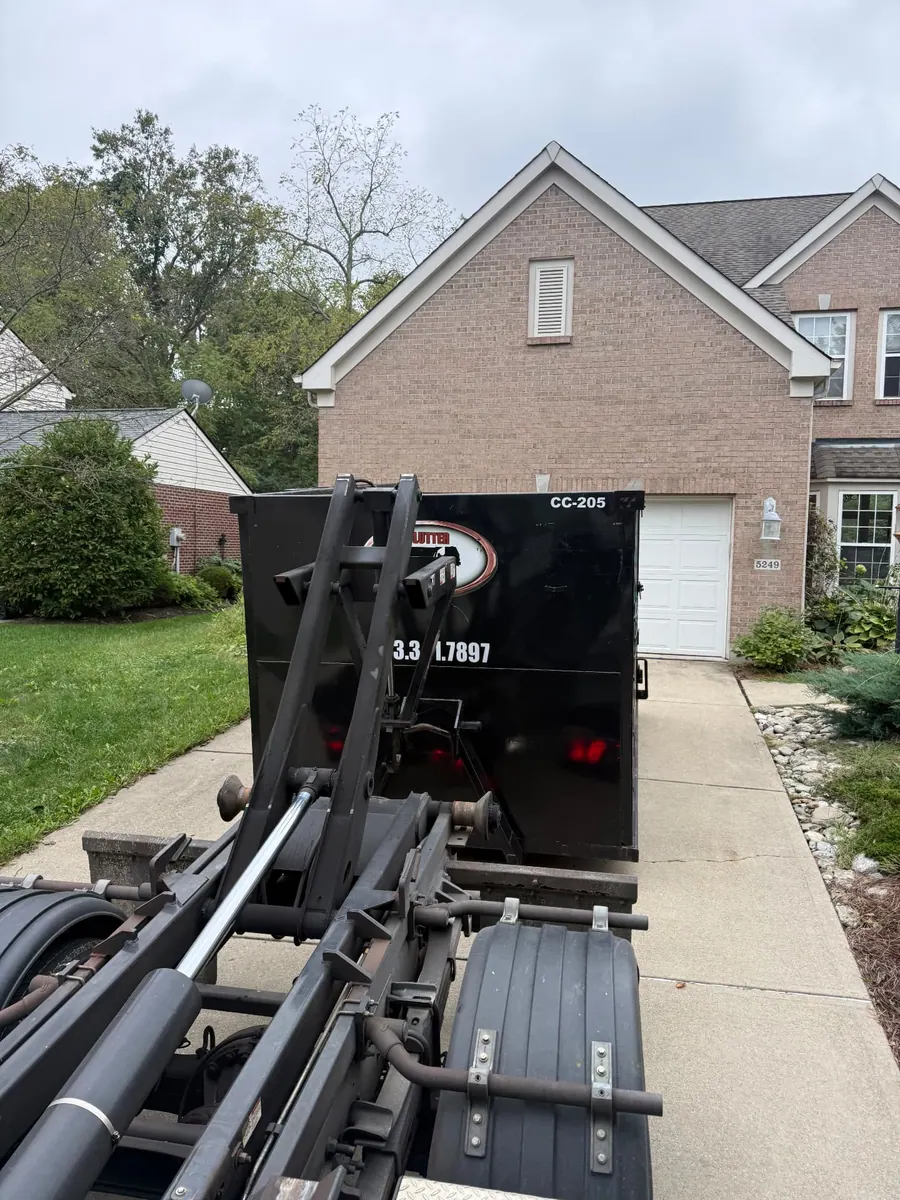 Clutter Cleanout 20 yard dumpster CC-205 delivered by roll-off truck to a residential driveway in Mason, OH