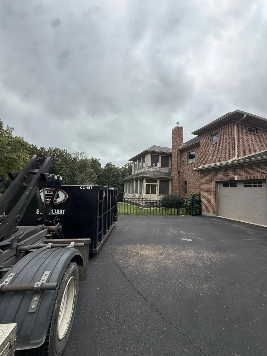 Clutter Cleanout 15 yard dumpster CC-157 delivered by roll-off truck to a residential driveway in Milford, OH