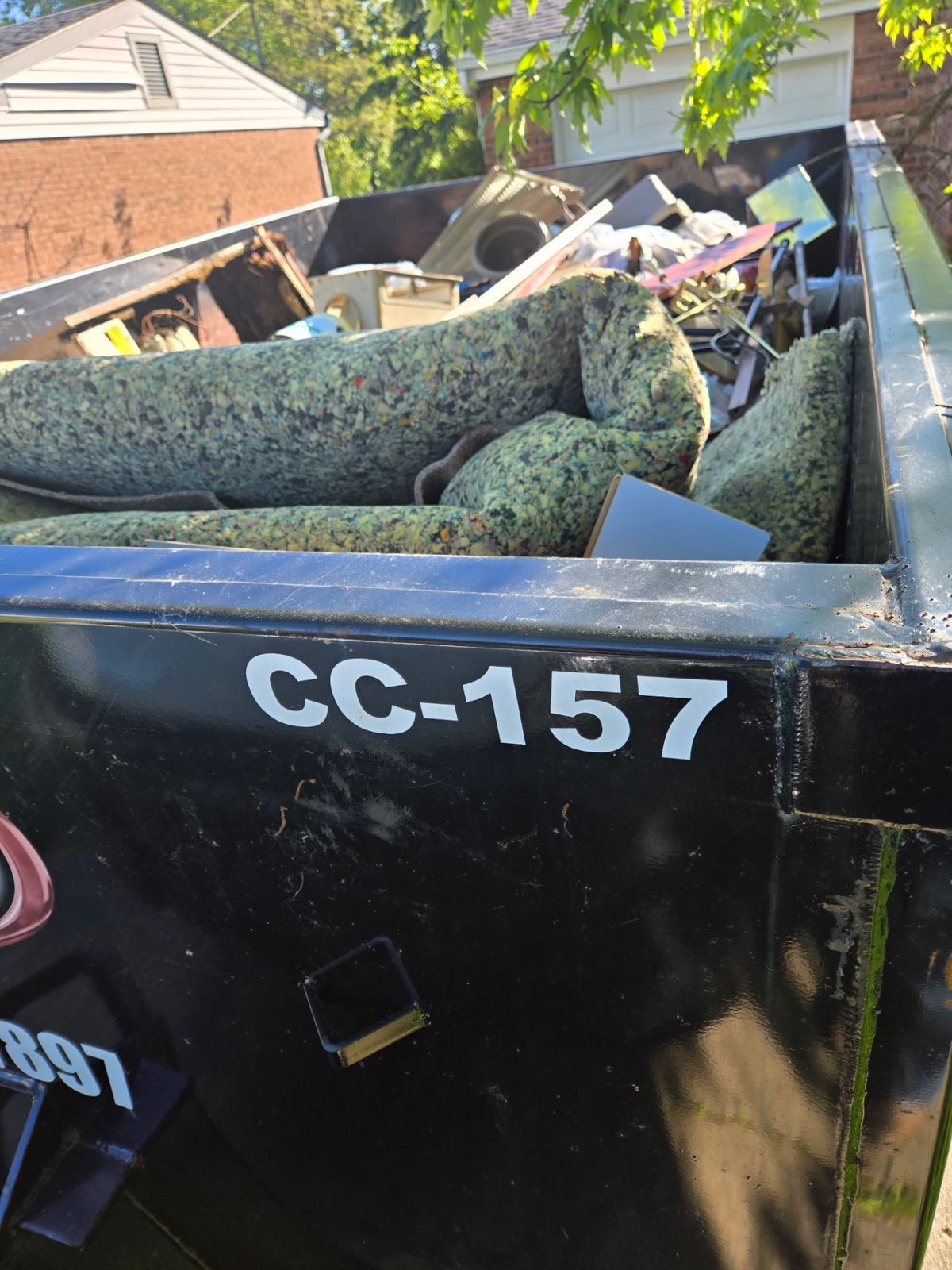 Loaded 15-yard construction dumpster in Alexandria, KY filled with carpet padding, drywall and remodel debris