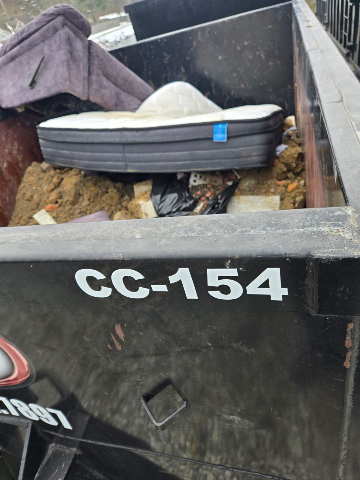Inside view of a loaded 15-yard dumpster with mattress and construction debris from an Alexandria, KY cleanout