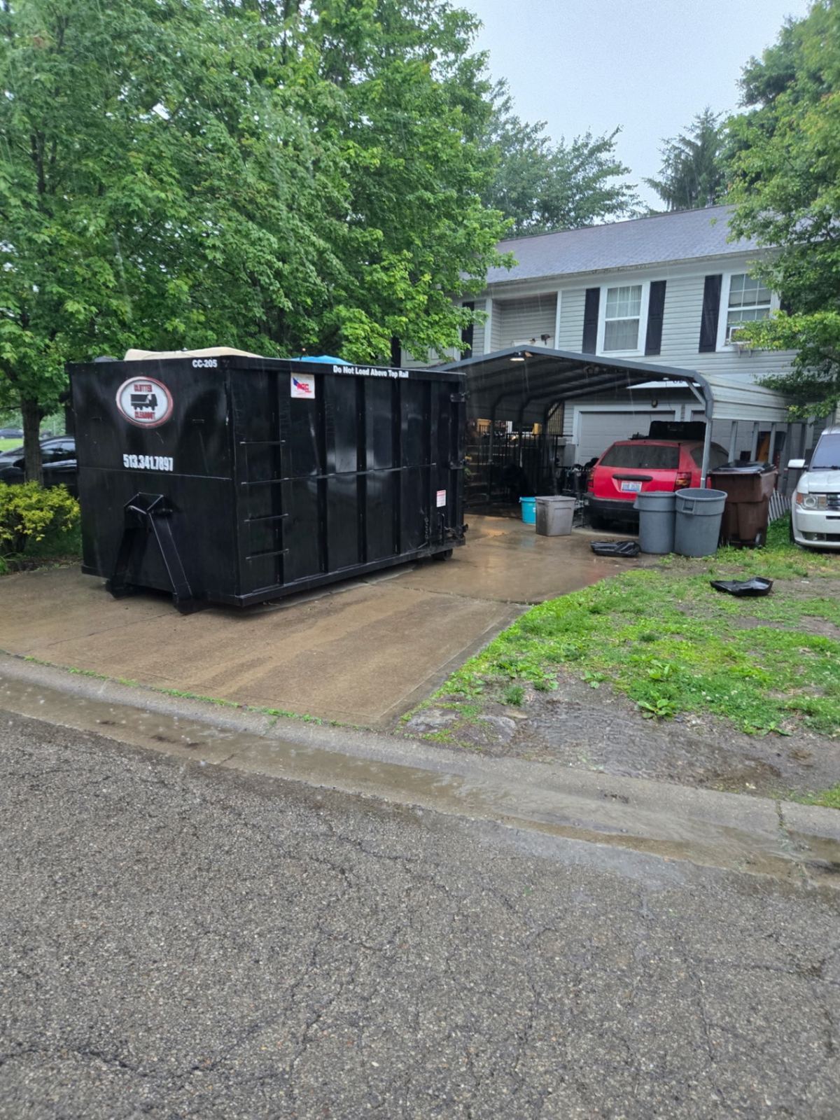 Clutter Cleanout 20-yard dumpster CC-205 on an Amelia OH driveway for a house cleanout