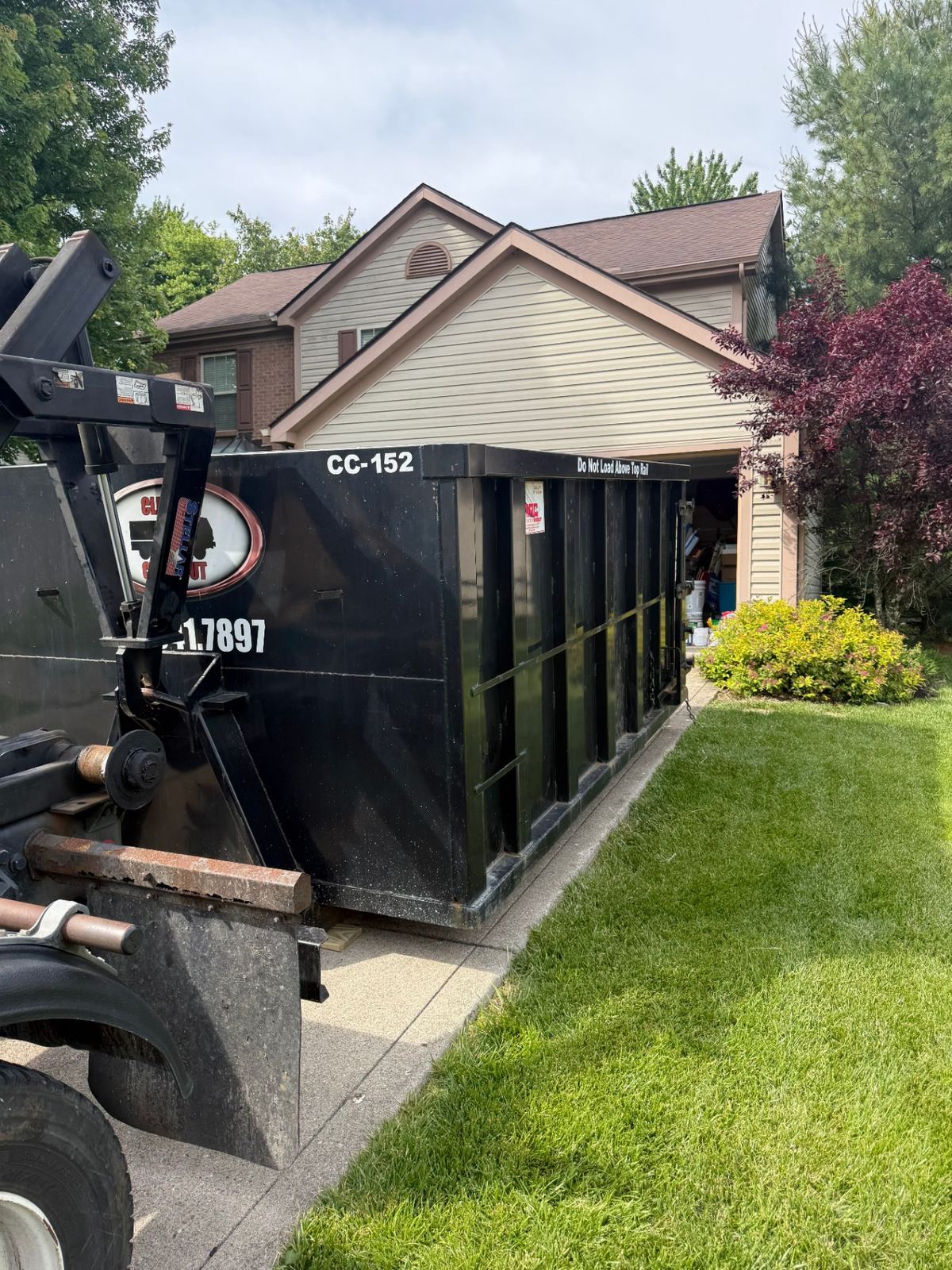 15 yard Clutter Cleanout dumpster CC-152 dropped on driveway for a garage cleanout in Batavia, OH