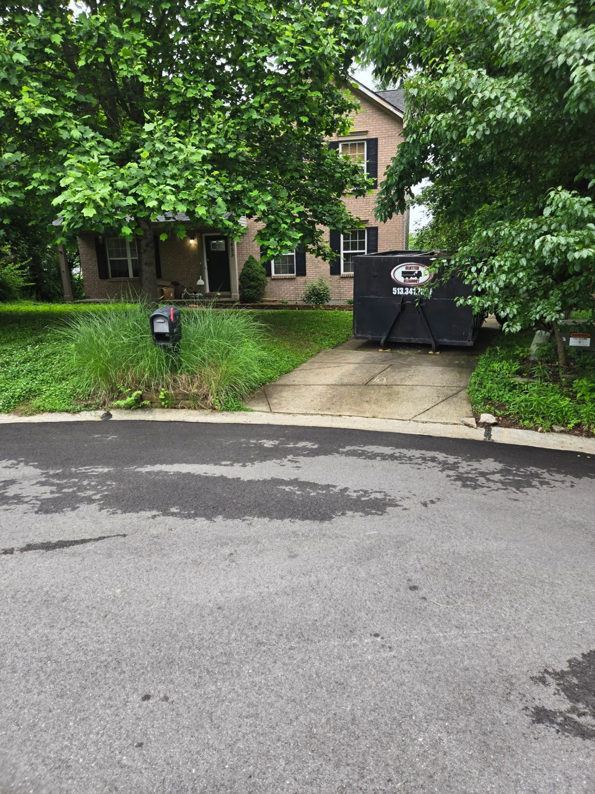 Clutter Cleanout 15 yard dumpster placed on a Burlington KY driveway for a residential cleanout job
