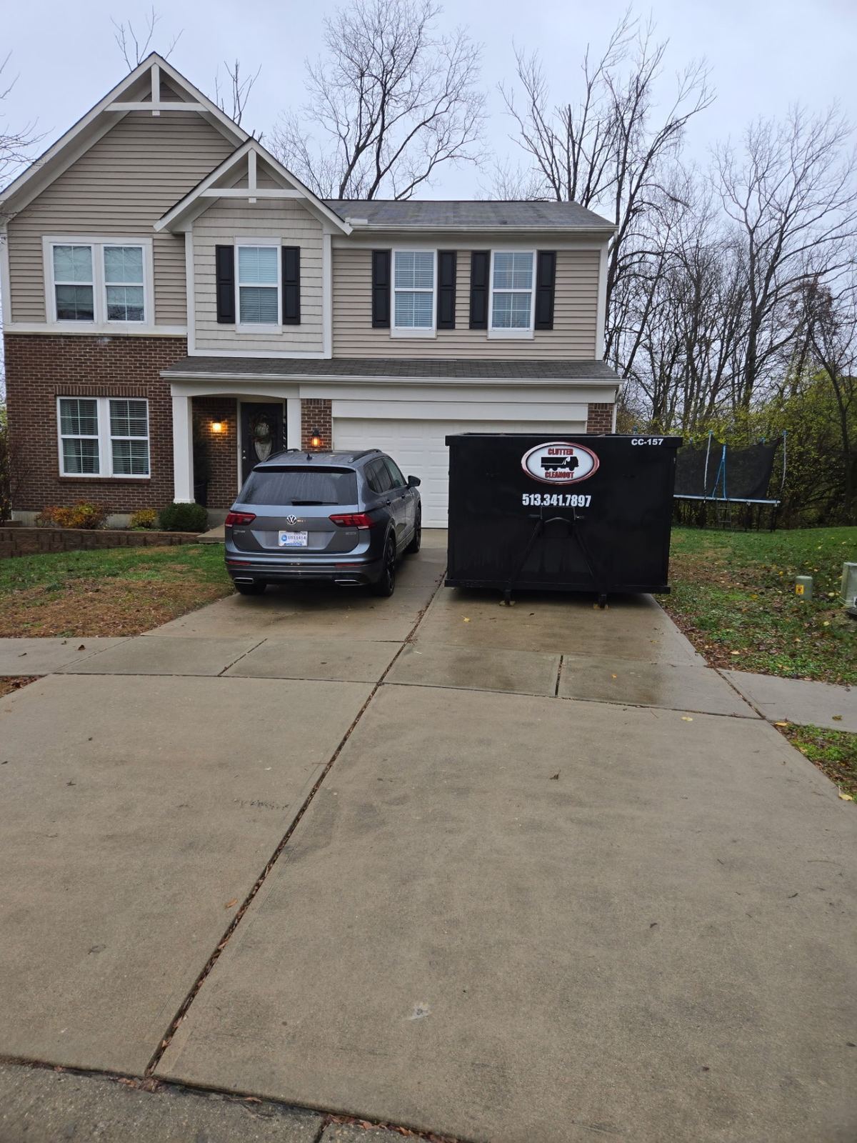 Dumpster rental delivered to Burlington KY driveway for garage cleanout