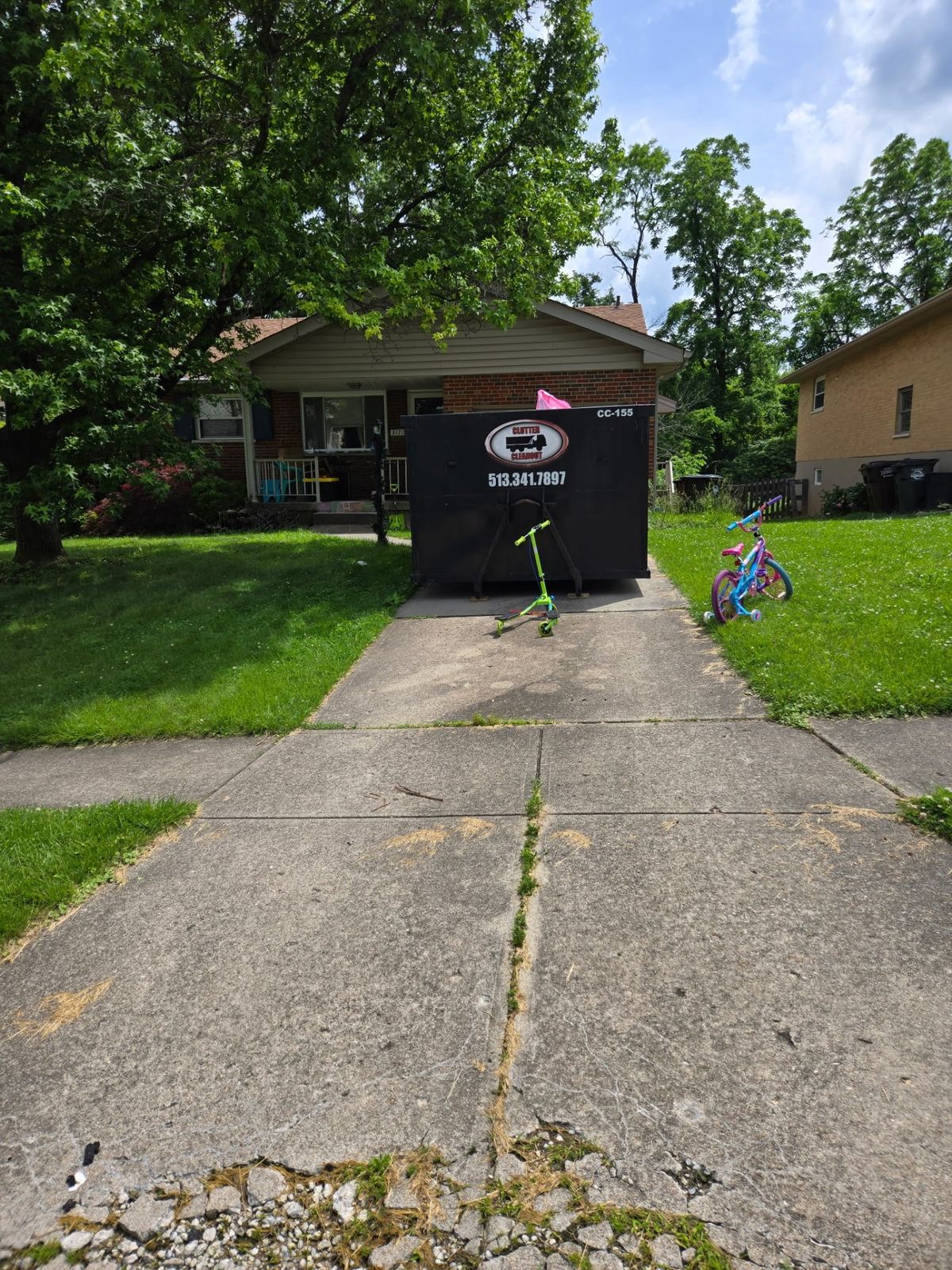 Clutter Cleanout 15 yard dumpster CC-155 set on a Covington KY driveway for a house cleanout