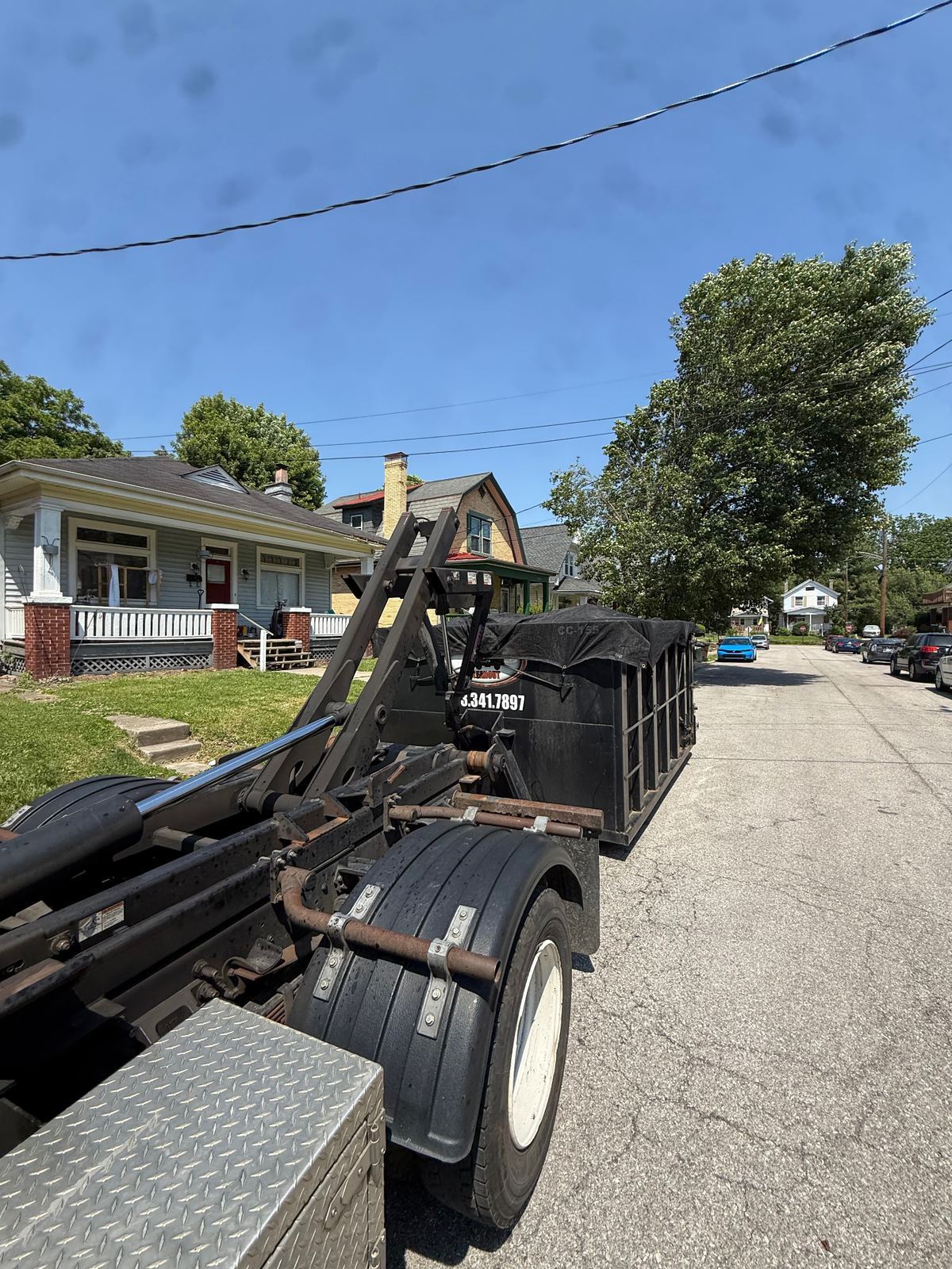 Clutter Cleanout 15 yard dumpster CC-155 tarped and being delivered to a Covington KY home for a house cleanout