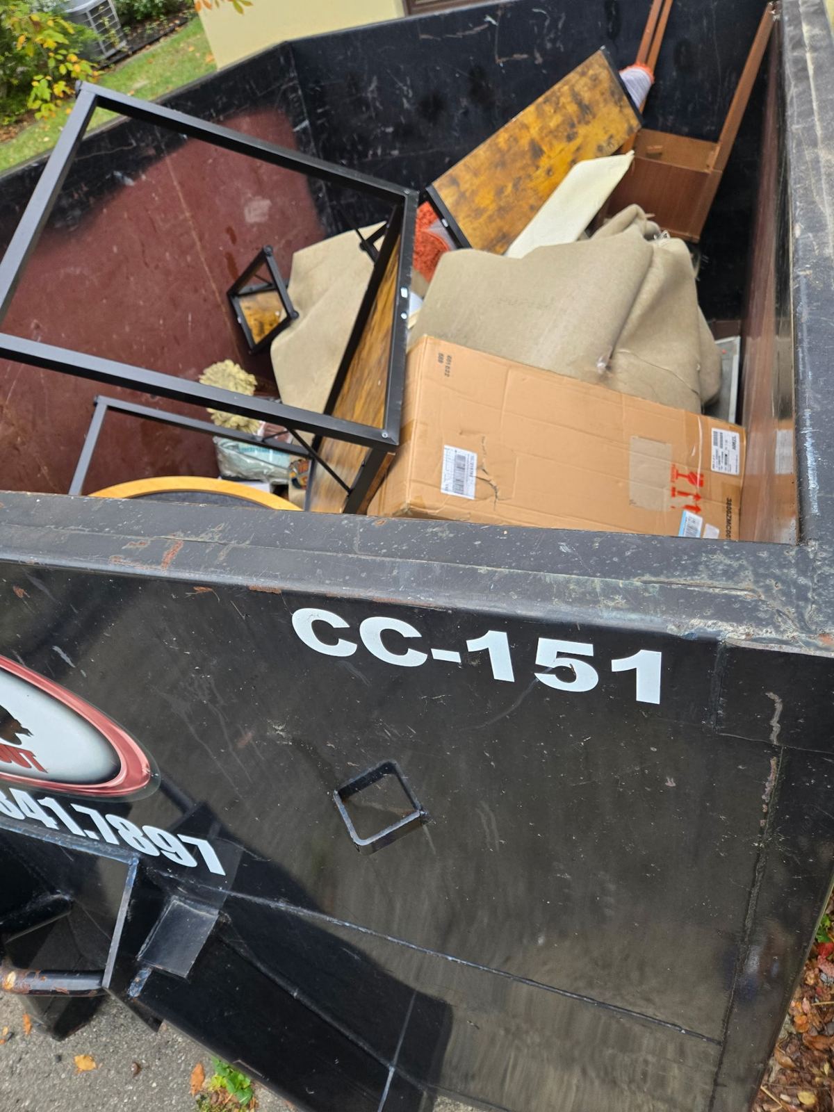 Loaded Clutter Cleanout dumpster CC-151 with furniture and junk from Covington cleanout