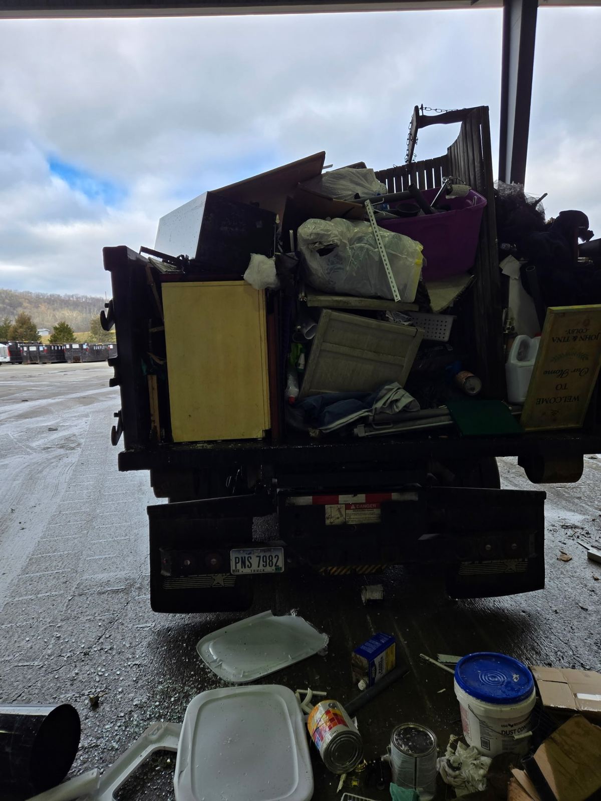 Full dumpster being hauled away from Crestview Hills KY cleanout job