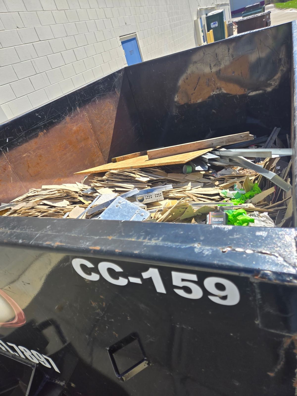 Inside view of dumpster CC-159 loaded with wood flooring and construction debris from a Florence, KY demolition