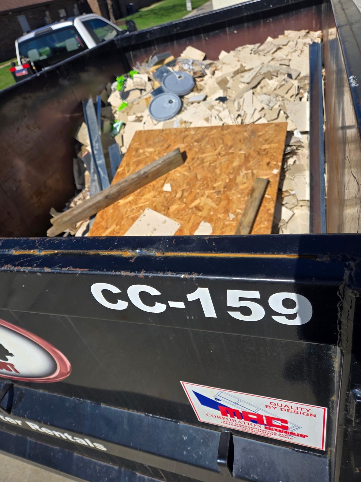 Overhead view of dumpster CC-159 filled with drywall, plywood, and demolition materials in Florence, Kentucky