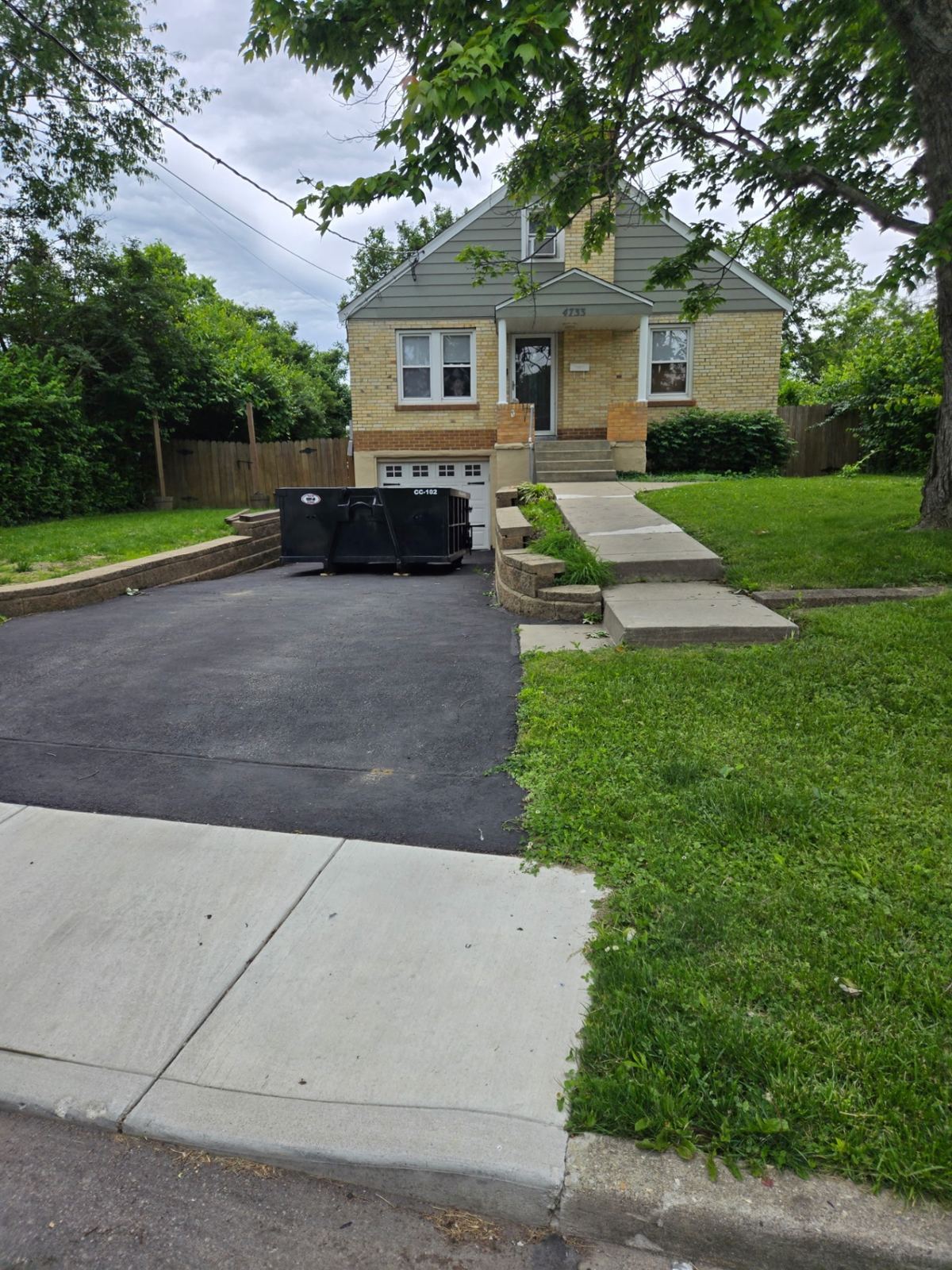 Clutter Cleanout 10-yard dumpster CC-102 on a Kenwood OH driveway for a house cleanout