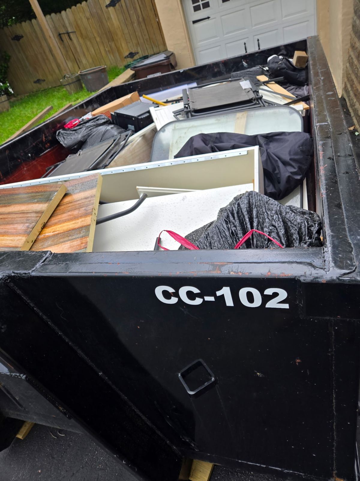 10-yard dumpster CC-102 loaded with household furniture and debris during a Kenwood OH cleanout