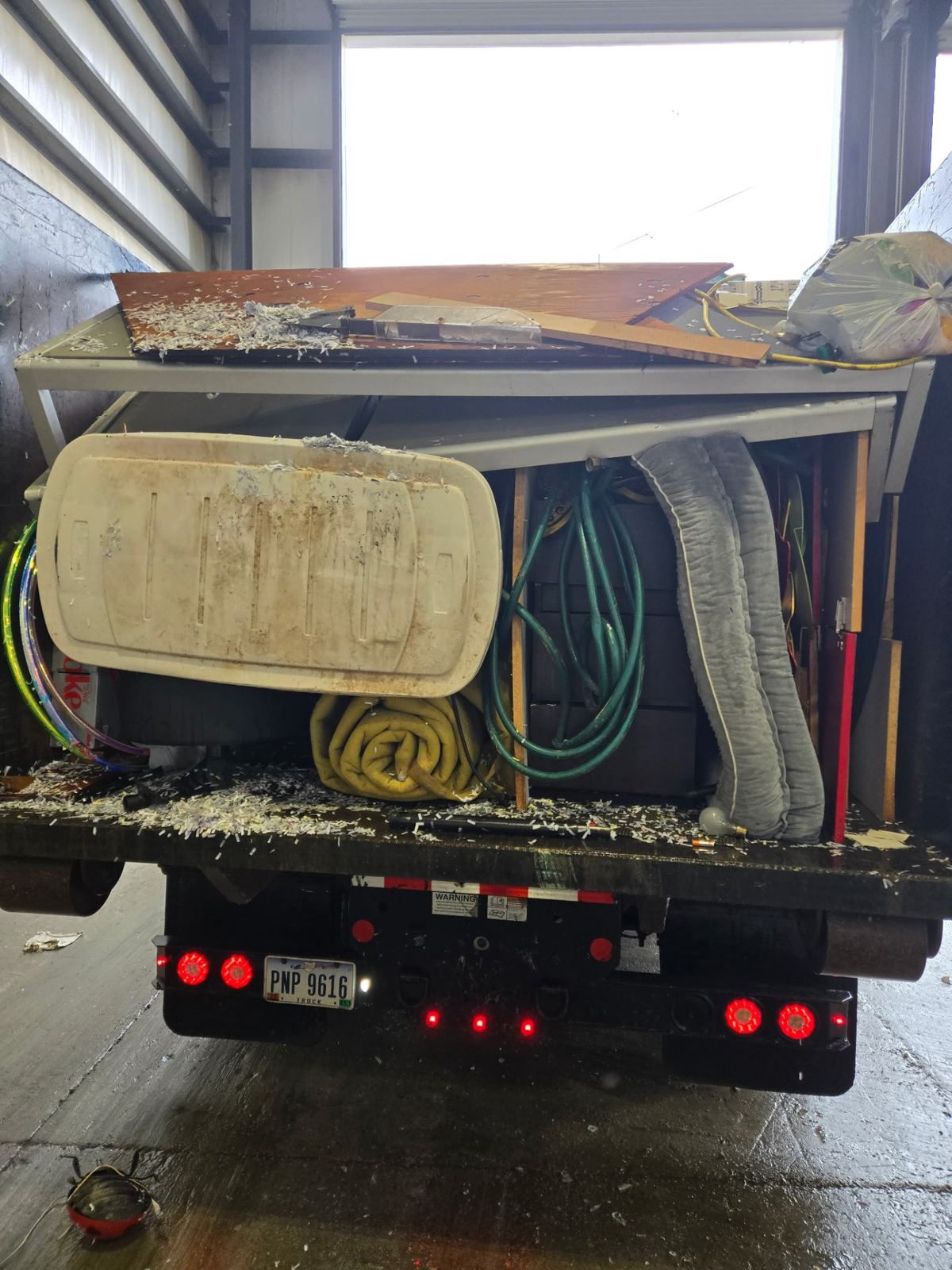Loaded dumpster with old furniture and debris from a Kenwood OH home cleanout project