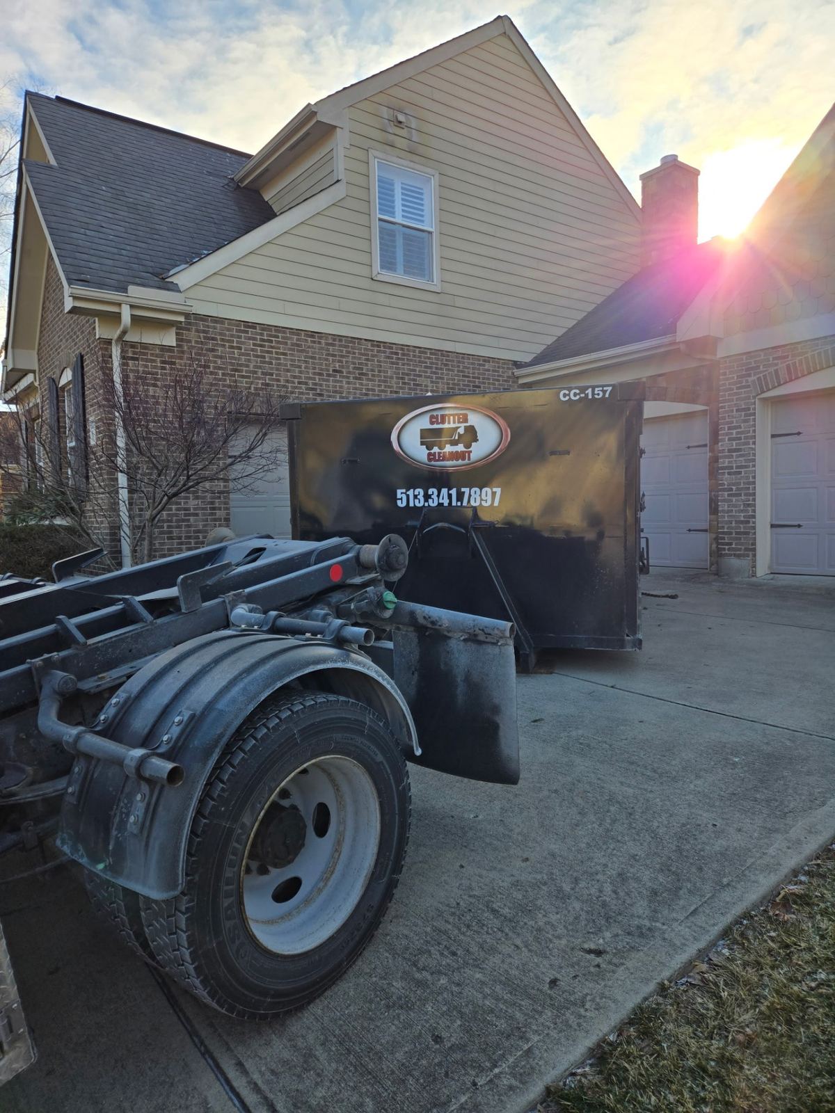 Clutter Cleanout dumpster CC-157 delivered to a Lebanon OH driveway at sunset for a home cleanout