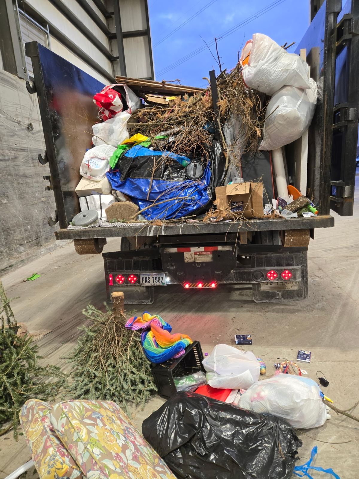 Fully loaded dumpster with yard waste furniture and household junk from a Lebanon OH cleanout project