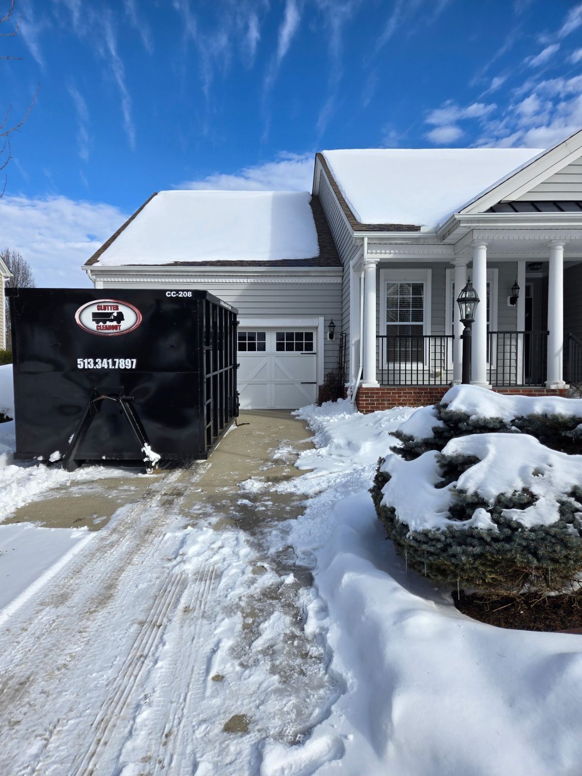 Clutter Cleanout dumpster CC-208 delivered to a snowy driveway in Madeira OH for a home cleanout