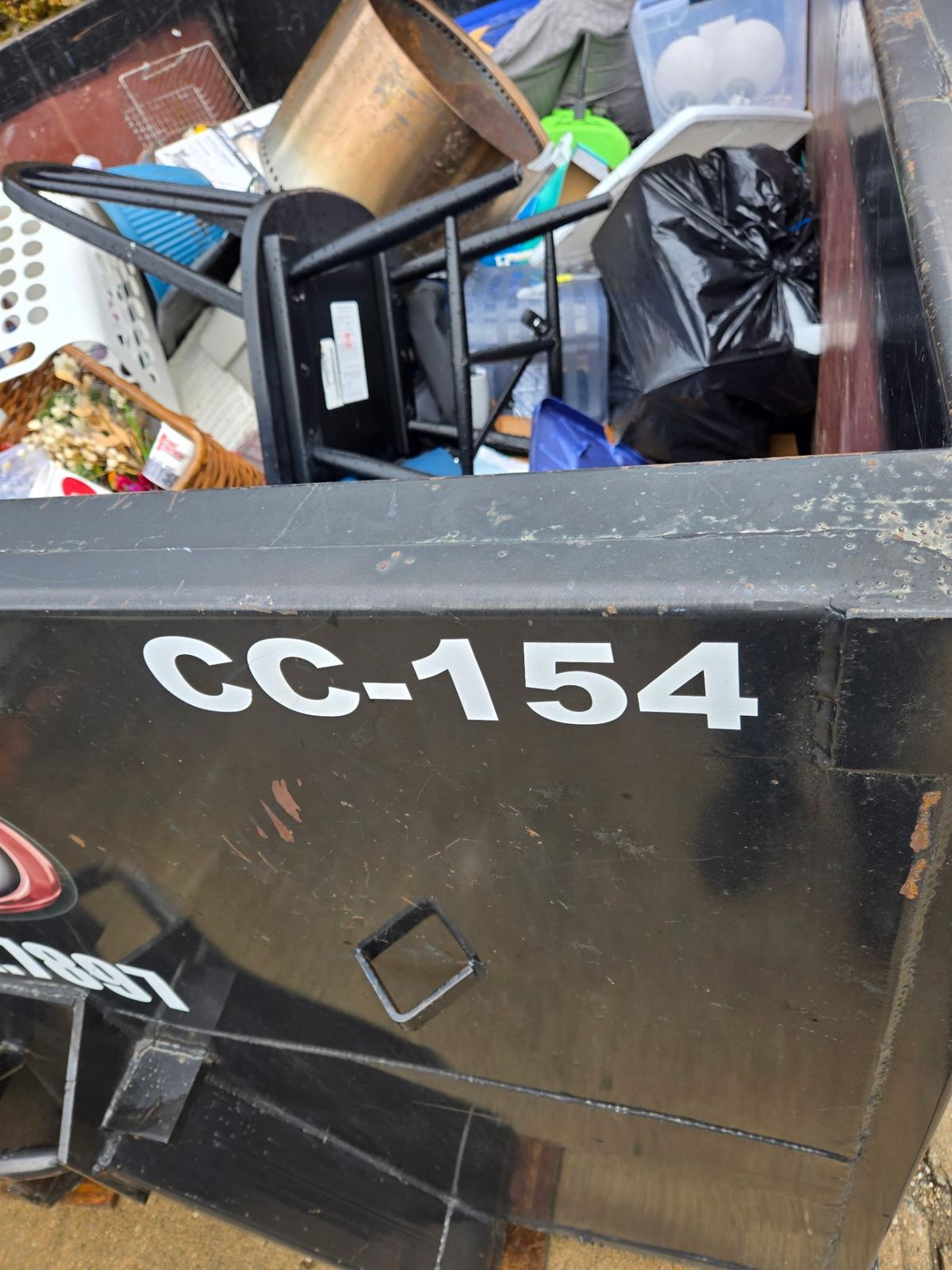 Close-up of Clutter Cleanout dumpster CC-154 loaded with household junk during a Mariemont OH cleanout project