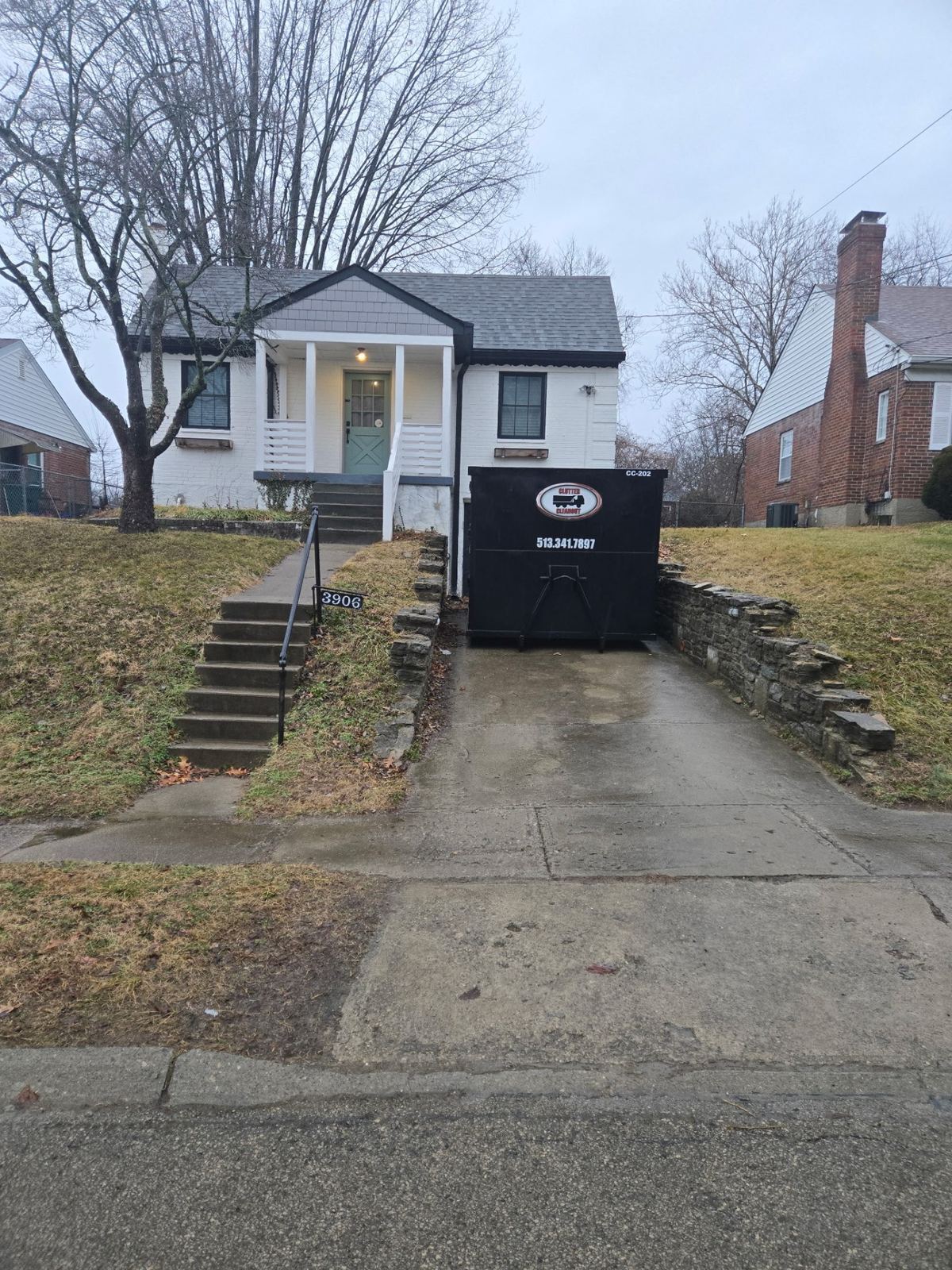 Clutter Cleanout dumpster CC-202 on driveway of a Norwood OH home for a garage cleanout