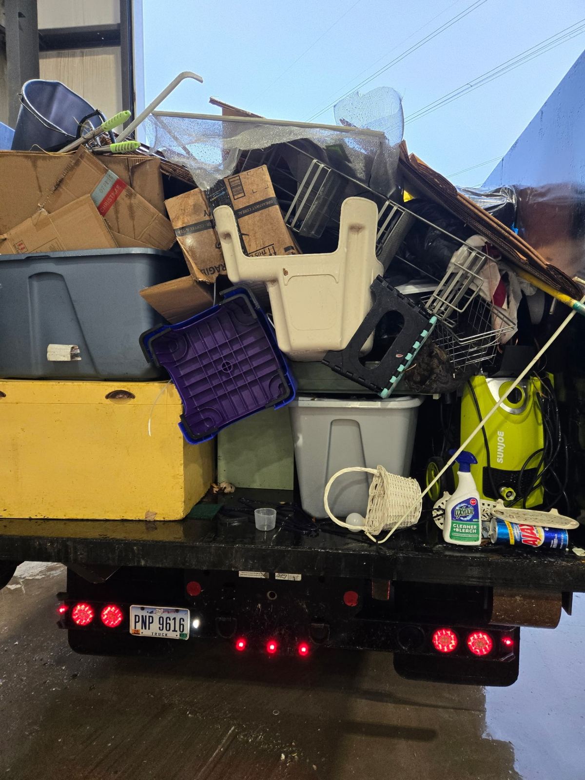 Fully loaded dumpster with household items and storage bins from a Sharonville OH property cleanout