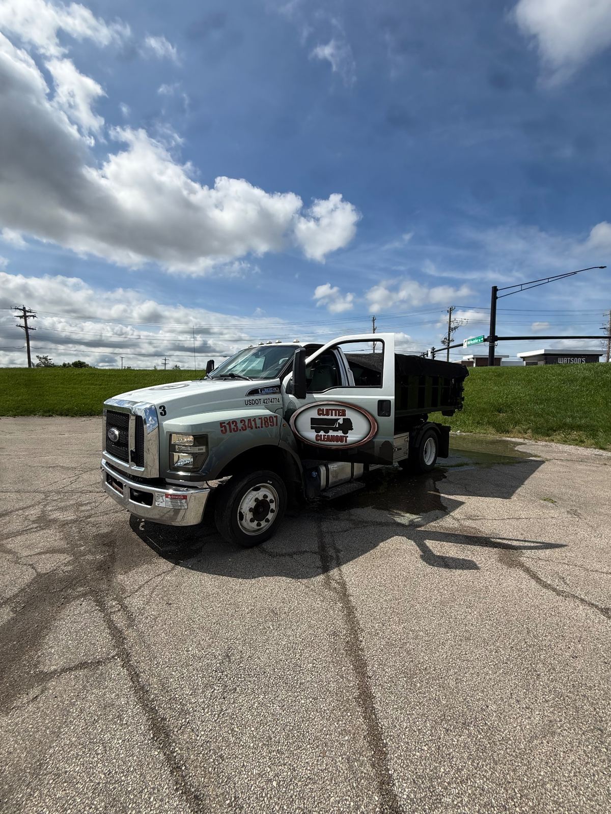 Clutter Cleanout truck #3 with 10 yard dumpster CC-102 staged in a Sharonville OH parking lot ready for delivery